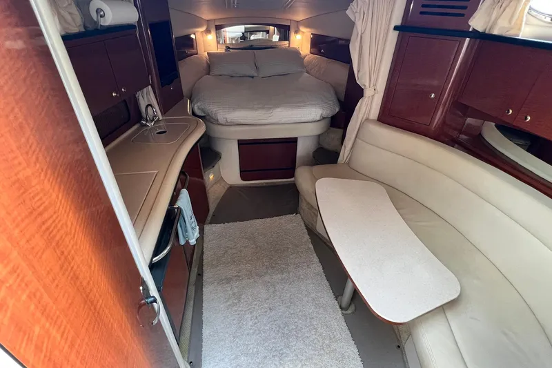 Slide: The Image of Interior of 2003 Sea Ray 320 Sundancer yacht with cozy seating and bed. - 16