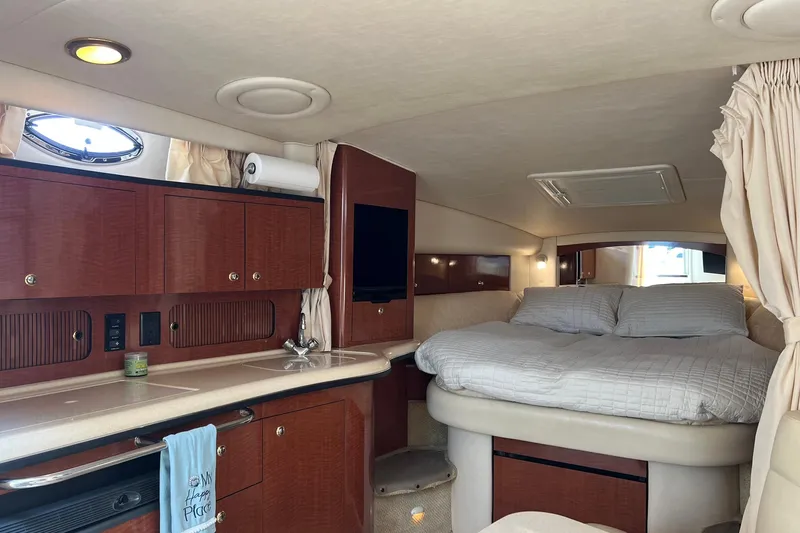 Slide: The Image of Interior of 2003 Sea Ray 320 Sundancer yacht with cozy bed and wooden cabinetry. - 17