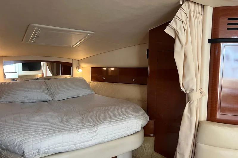 Slide: The Image of Interior cabin of 2003 Sea Ray 320 Sundancer with cozy bed and elegant wood finish. - 23