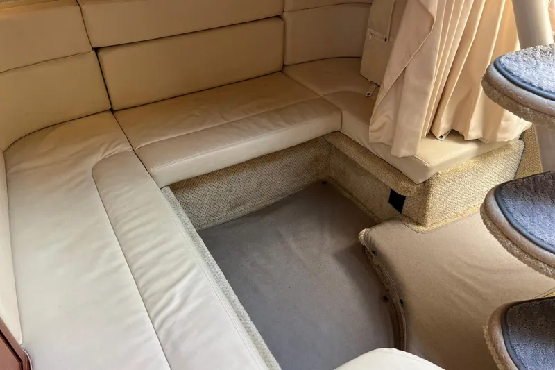 Slide: The Image of Interior of 2003 Sea Ray 320 Sundancer with beige seating and carpeted flooring. - 28