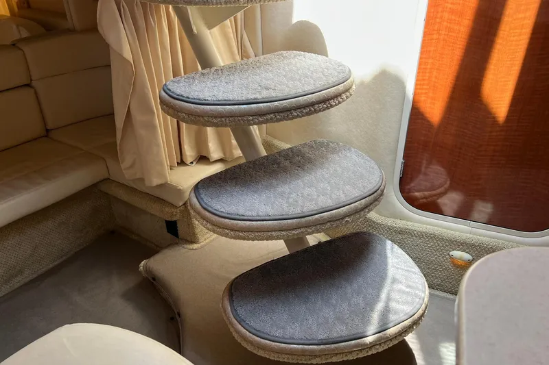 Slide: The Image of Interior of 2003 Sea Ray 320 Sundancer with carpeted steps and seating area. - 30