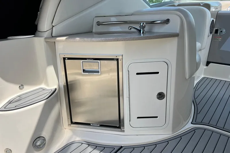 Slide: The Image of 2003 Sea Ray 320 Sundancer cockpit with sink and stainless steel fridge. - 4