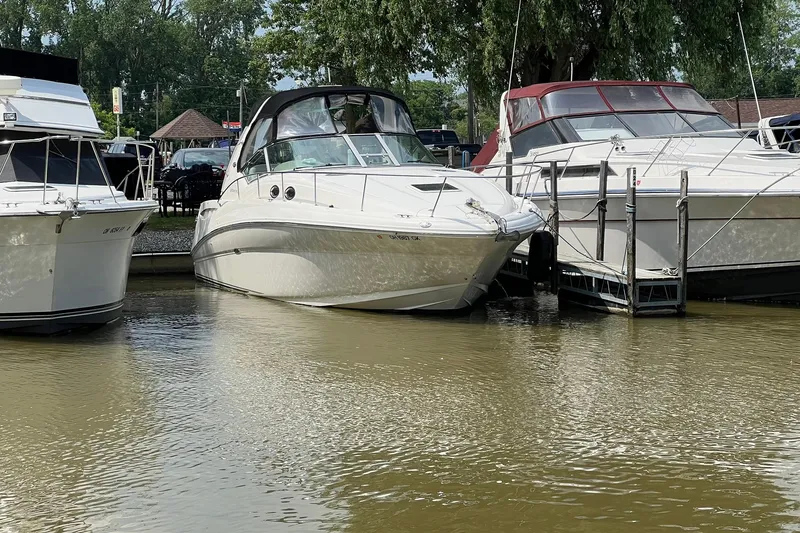 Slide: The Image of 2003 Sea Ray 320 Sundancer docked between boats in a marina. - 40