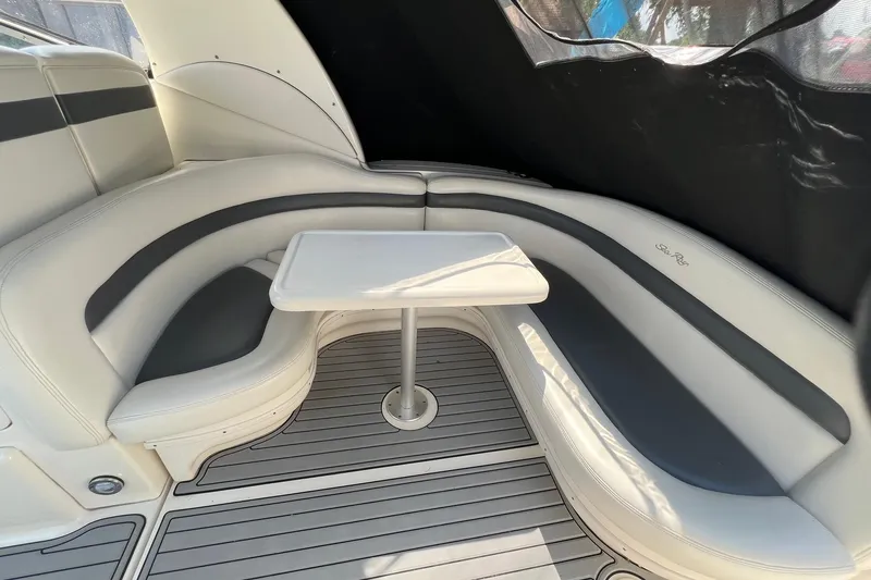 Slide: The Image of 2003 Sea Ray 320 Sundancer interior with curved seating and table. - 7