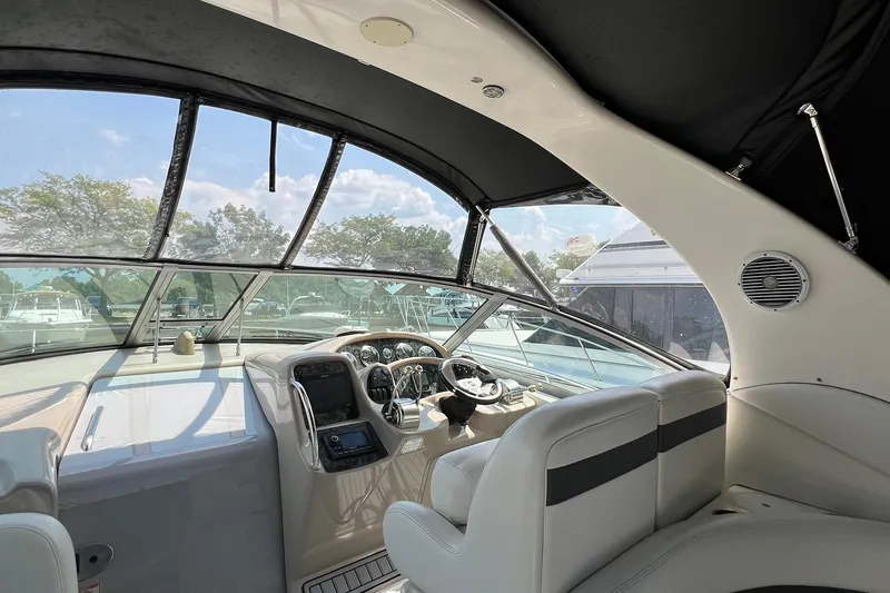 Slide: The Image of Interior view of 2003 Sea Ray 320 Sundancer yacht cockpit with steering wheel and seating. - 8