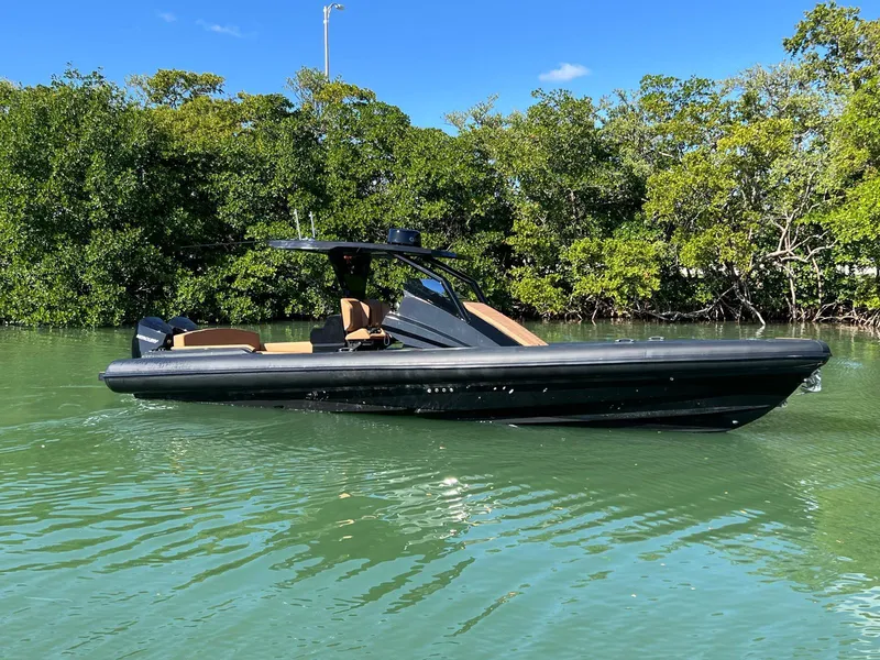 Slide: The Image of 2026 Novielli Veloche 349 boat on calm water, surrounded by lush greenery. - 10
