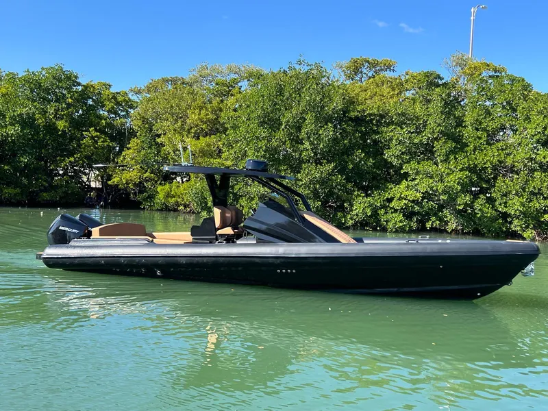 Slide: The Image of Sleek 2026 Novielli Veloche 349 boat on calm water, surrounded by lush greenery. - 15