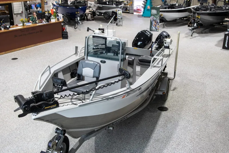 Slide: The Image of 2018 Gregor Eagle 20 boat displayed in a showroom with various other boats. - 3