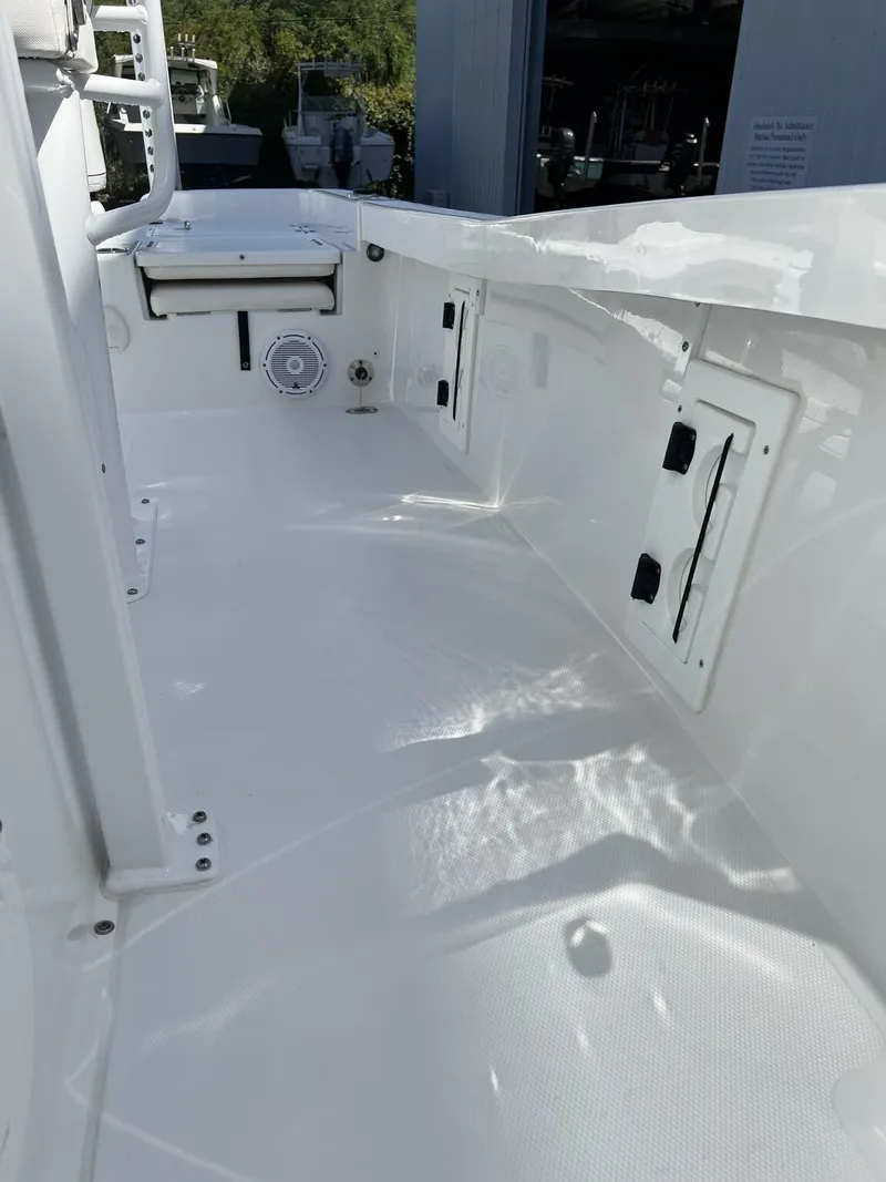 Slide: The Image of 2023 Sea Hunt BX Series BX 25 BR boat interior, showcasing sleek white deck design. - 4