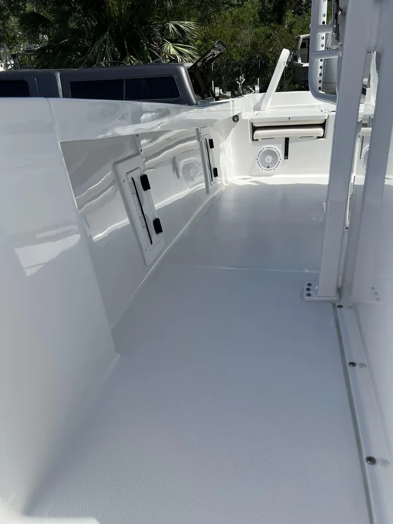 Slide: The Image of 2023 Sea Hunt BX Series BX 25 BR boat interior, featuring sleek white deck and storage compartments. - 5