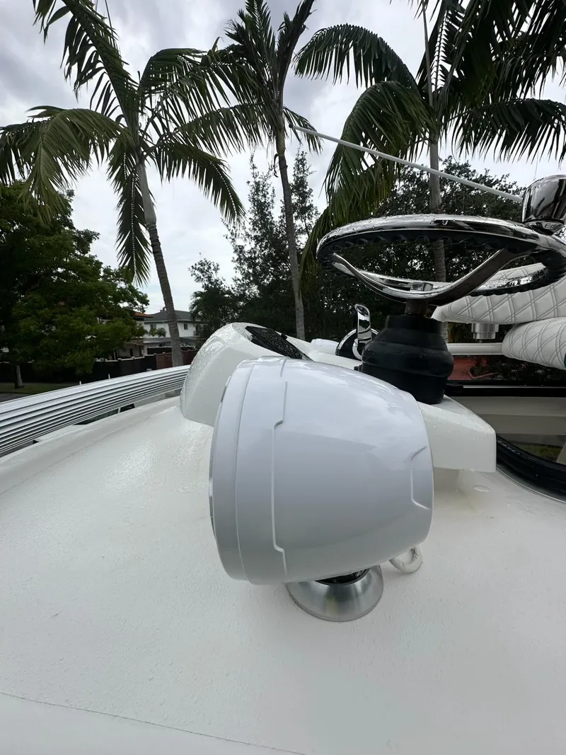 Slide: The Image of Boat deck with steering wheel and spotlight, surrounded by palm trees. - 17