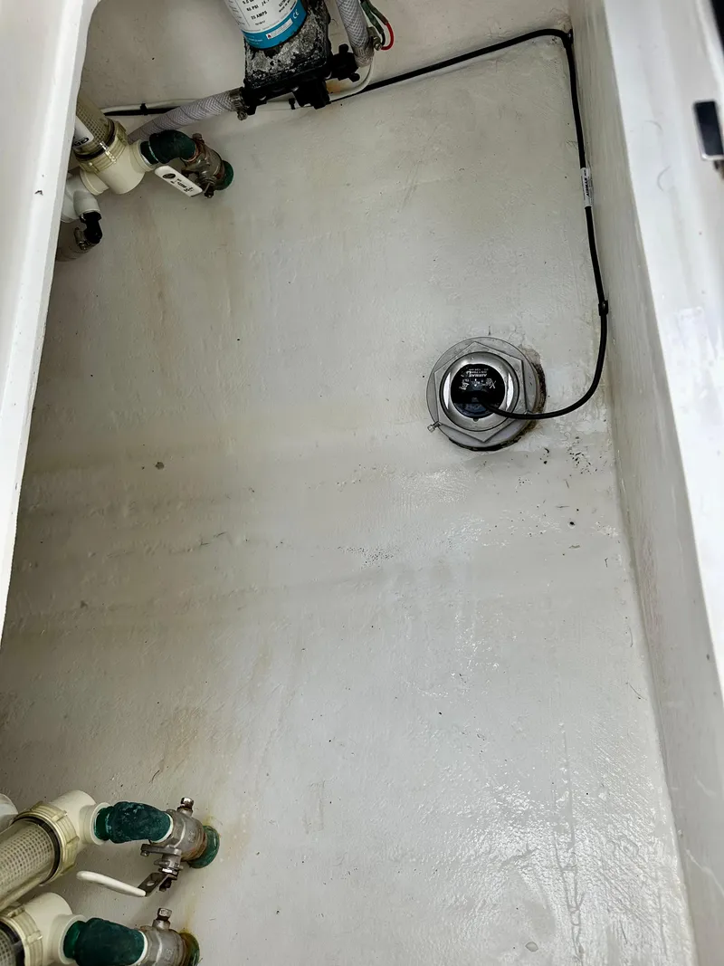 Slide: The Image of Clean boat bilge area with visible plumbing and wiring, Young 27 model, 2019. - 27