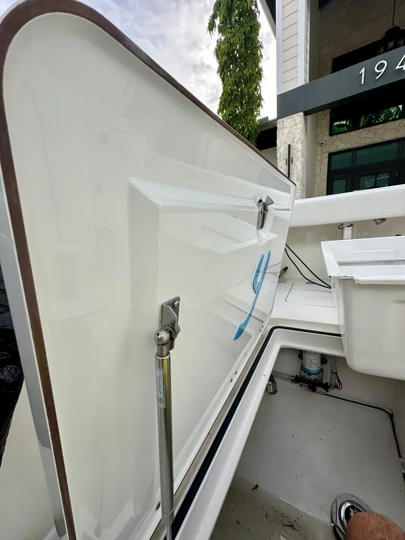 Slide: The Image of Open storage compartment on a 2019 Young 27 boat, showcasing interior details. - 28