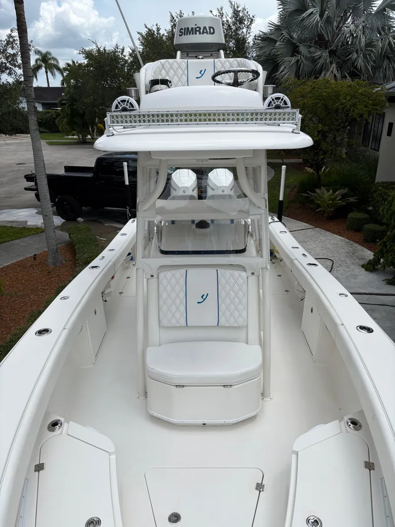 Slide: The Image of Young 27 boat, 2019 model, featuring a sleek white deck and advanced navigation equipment. - 3