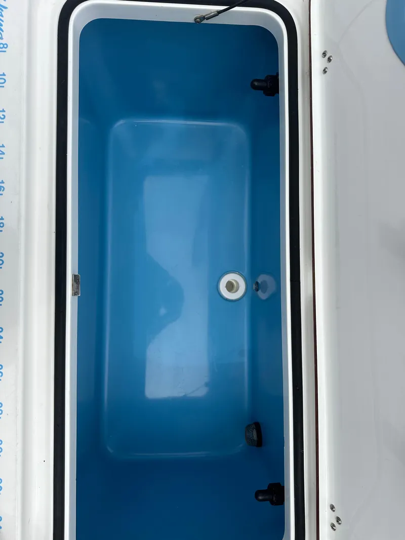 Slide: The Image of Blue interior compartment of a 2019 Young 27 model boat. - 37