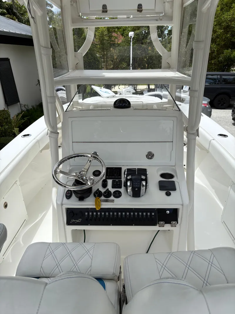 Slide: The Image of Center console of a 2019 Young 27 boat with steering wheel and controls. - 4