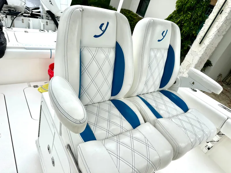 Slide: The Image of Luxury boat seats with white and blue upholstery, featuring diamond stitching, 2019 Young 27 model. - 6