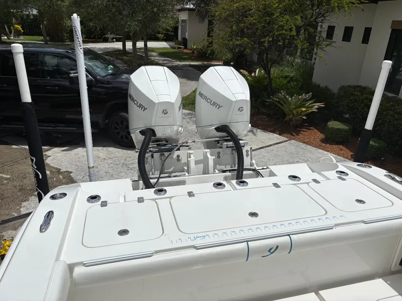 Slide: The Image of Rear view of a 2019 Young 27 boat with dual Mercury outboard engines. - 8