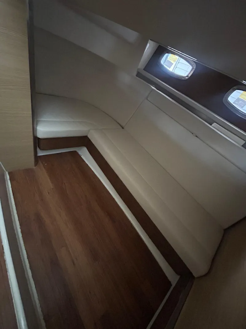 Slide: The Image of Interior cabin of 2014 Chaparral 327 SSX with wood flooring and cushioned seating. - 18