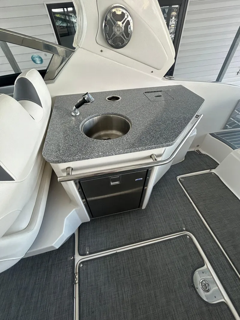 Slide: The Image of 2014 Chaparral 327 SSX boat interior with sink and mini fridge. - 6