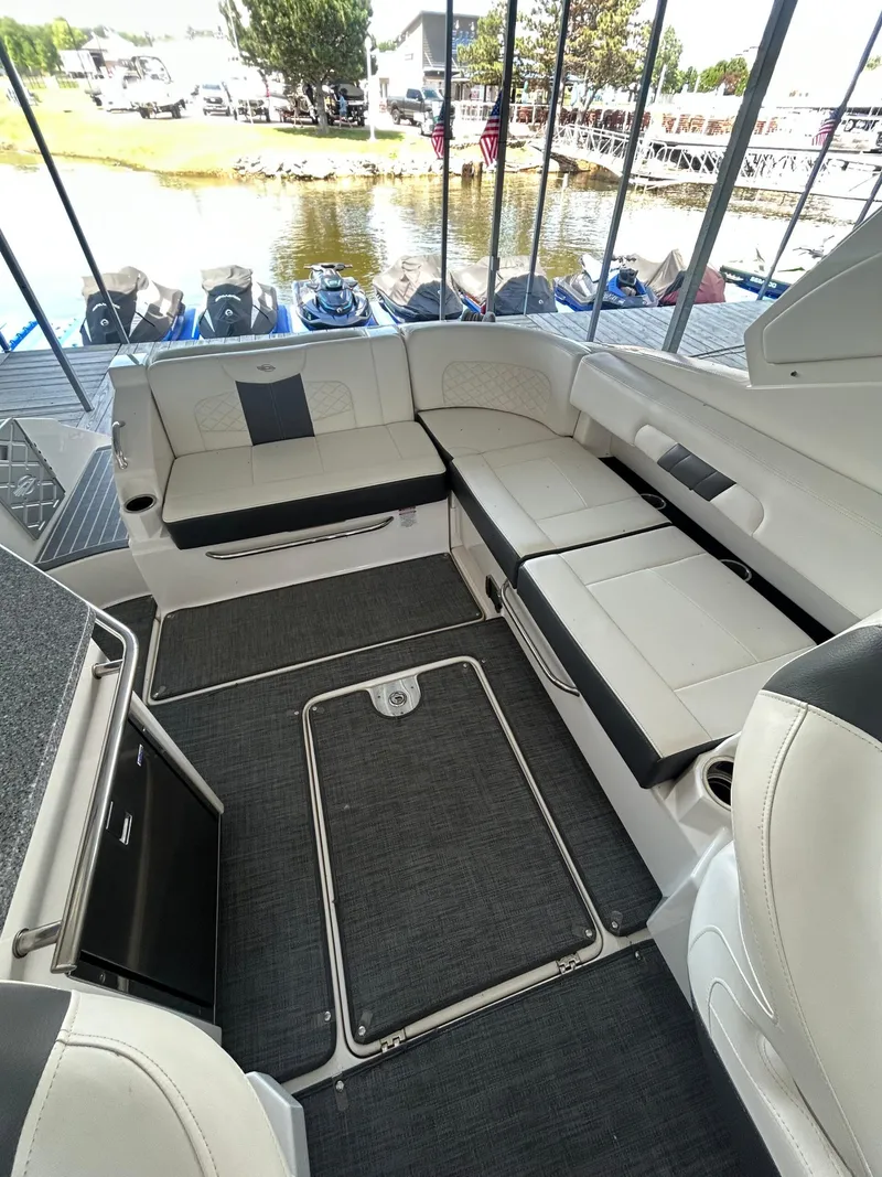 Slide: The Image of 2014 Chaparral 327 SSX boat interior with white seating and lake view. - 7