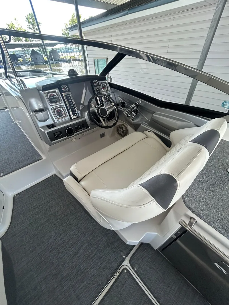 Slide: The Image of 2014 Chaparral 327 SSX boat cockpit with modern steering and control panel. - 8