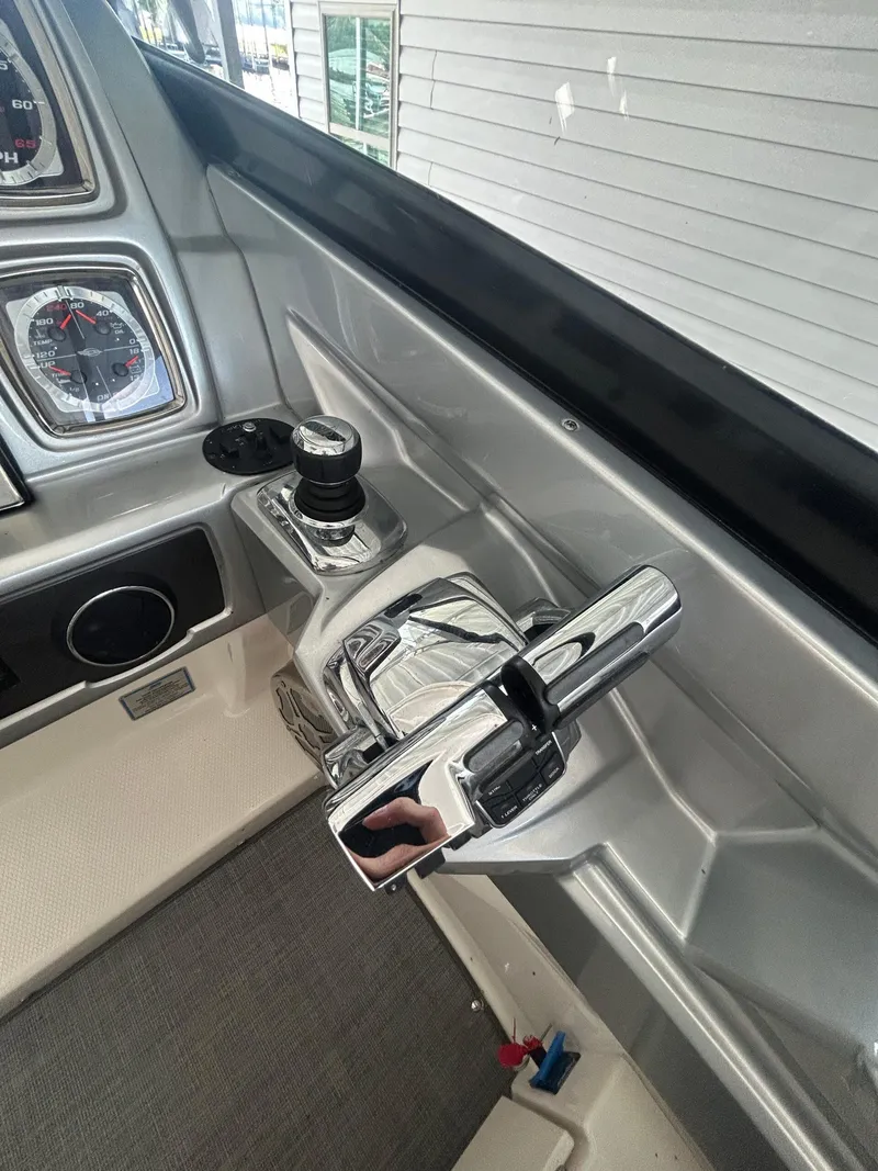 Slide: The Image of Control panel of a 2014 Chaparral 327 SSX boat with chrome throttle and gauges. - 9