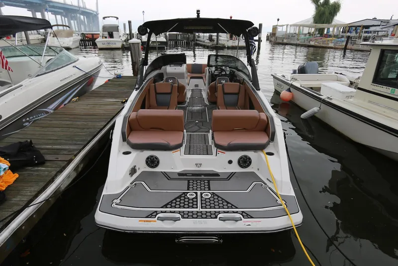Slide: The Image of 2017 Scarab 255 Impulse boat docked, featuring spacious seating and modern design. - 10