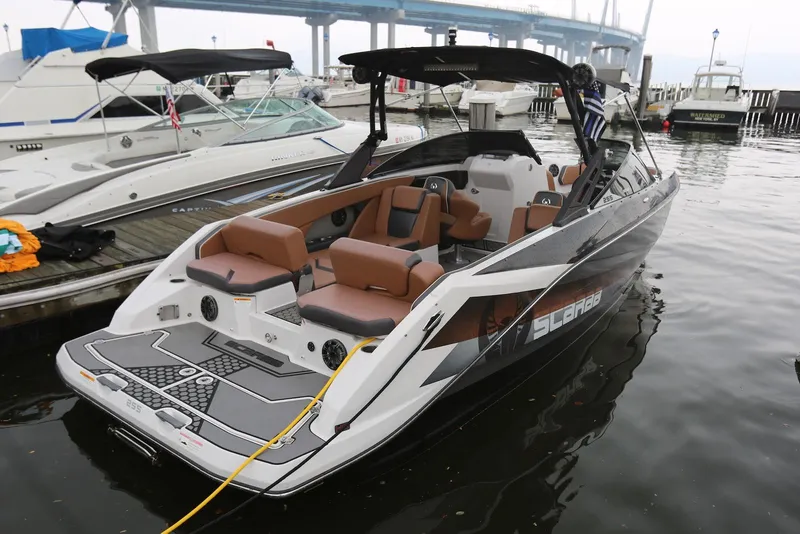 Slide: The Image of 2017 Scarab 255 Impulse boat docked, featuring sleek design and comfortable seating. - 11
