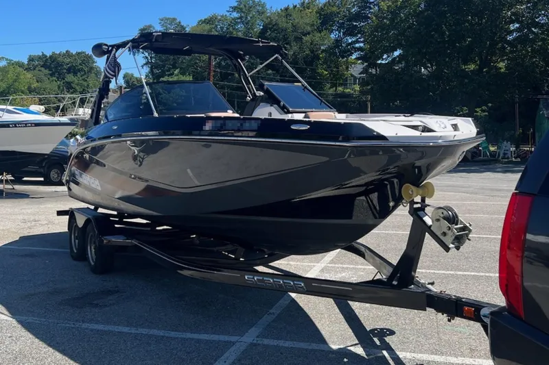 Slide: The Image of 2017 Scarab 255 Impulse boat on trailer in parking lot. - 2