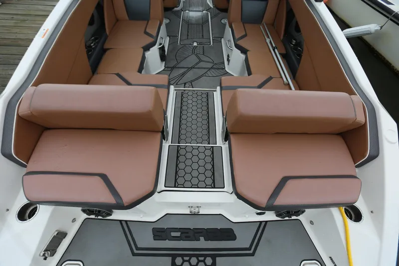 Slide: The Image of 2017 Scarab 255 Impulse boat interior with brown seating and modern design. - 20