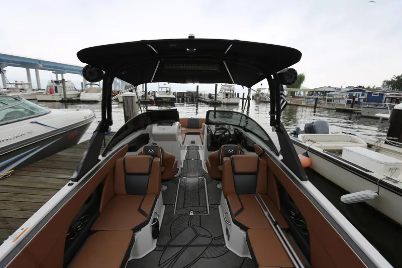 Slide: The Image of 2017 Scarab 255 Impulse boat interior at marina, featuring sleek design and comfortable seating. - 22