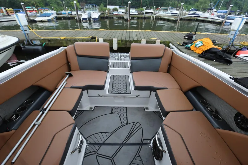 Slide: The Image of 2017 Scarab 255 Impulse boat interior with brown seating, docked at marina. - 24