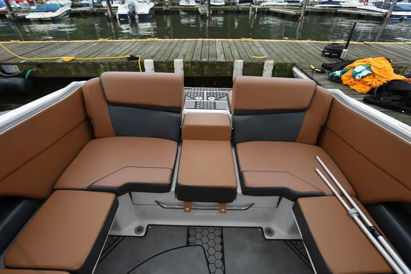 Slide: The Image of 2017 Scarab 255 Impulse boat interior with brown seating, docked at marina. - 25