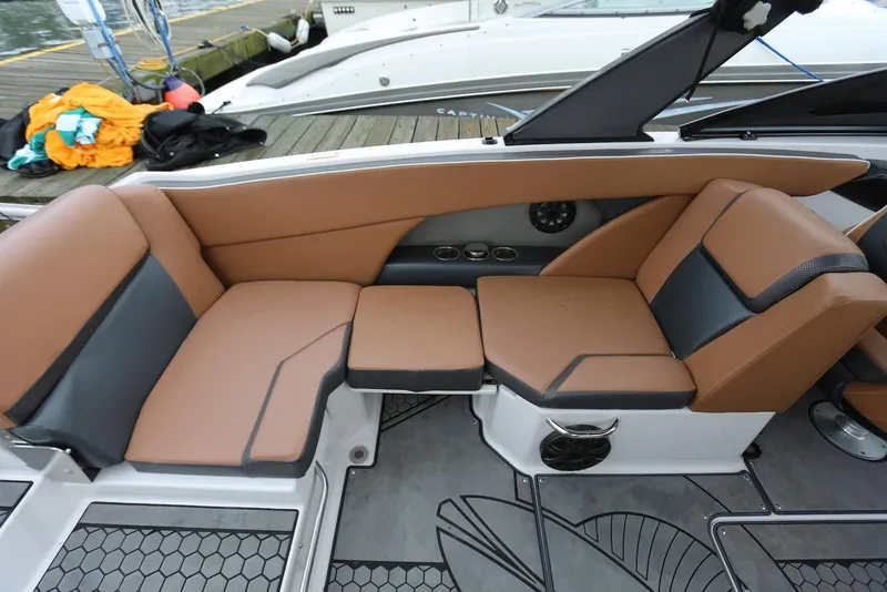 Slide: The Image of 2017 Scarab 255 Impulse boat interior with brown and black seating, dockside view. - 27