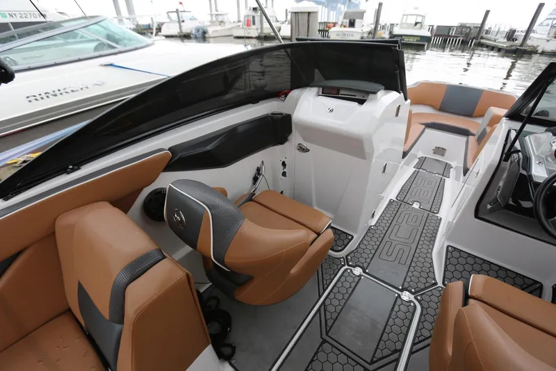 Slide: The Image of 2017 Scarab 255 Impulse boat interior with tan seating and modern dashboard. - 28