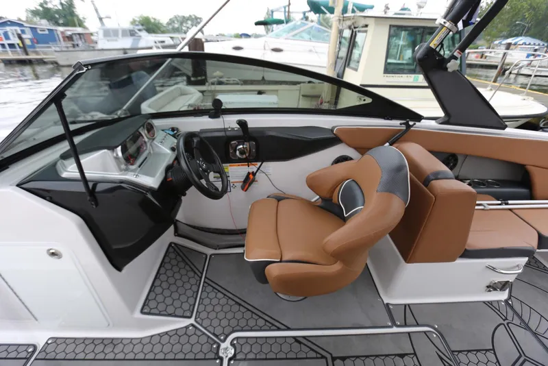 Slide: The Image of Interior of 2017 Scarab 255 Impulse boat with brown seating and modern dashboard. - 31