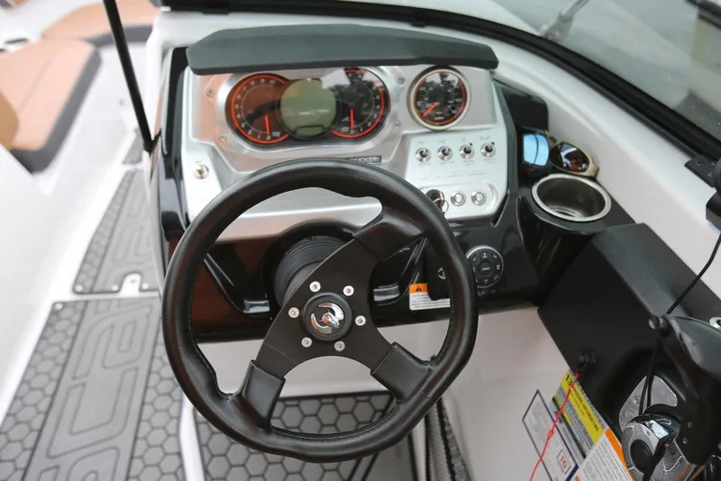 Slide: The Image of Steering wheel and dashboard of 2017 Scarab 255 Impulse boat, featuring gauges and controls. - 34