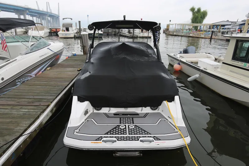 Slide: The Image of 2017 Scarab 255 Impulse boat docked, covered with a black tarp. - 4