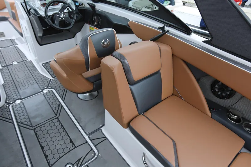 Slide: The Image of 2017 Scarab 255 Impulse boat interior with tan and black seating, modern dashboard, and speaker system. - 42