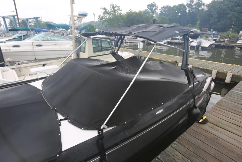 Slide: The Image of 2017 Scarab 255 Impulse boat with black cover docked at marina. - 7