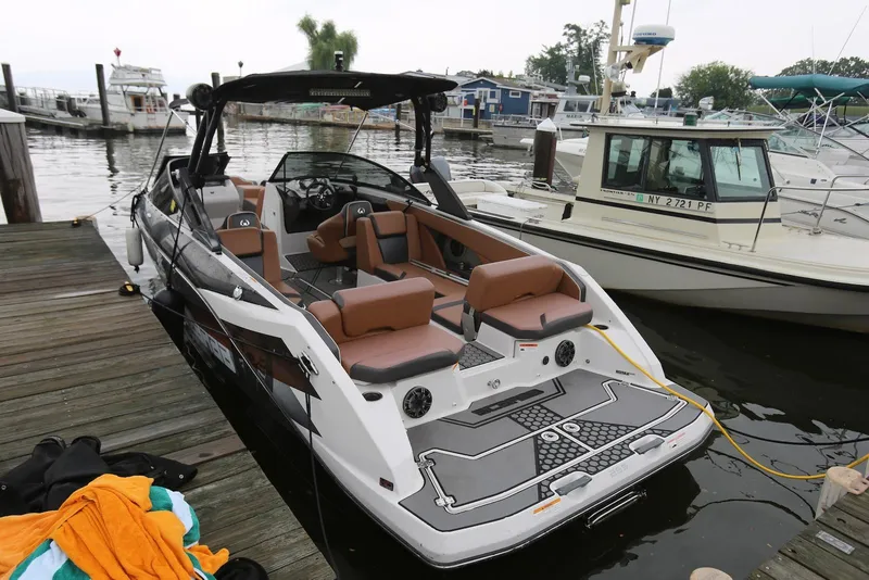 Slide: The Image of 2017 Scarab 255 Impulse boat docked at a marina, featuring sleek design and comfortable seating. - 9