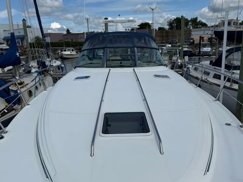 Slide: The Image of 2003 Sea Ray 380 Sundancer yacht docked at marina, showcasing sleek deck design. - 10