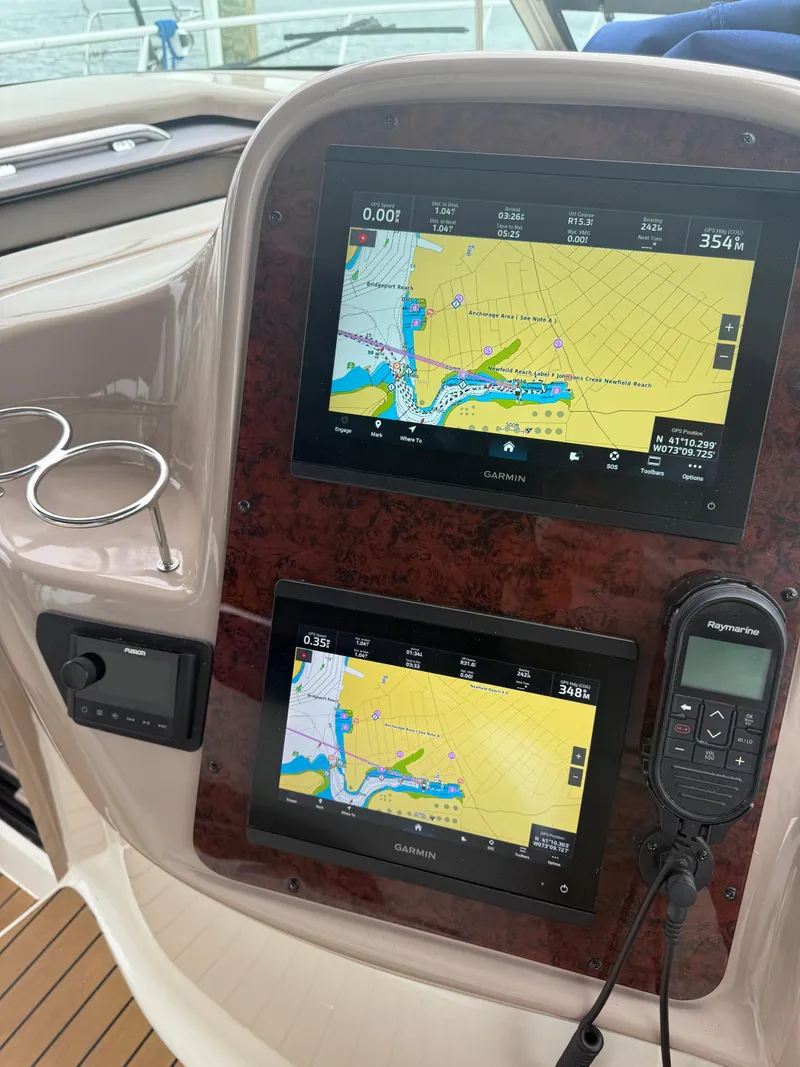 Slide: The Image of Control panel of a 2003 Sea Ray 380 Sundancer with Garmin navigation displays. - 17