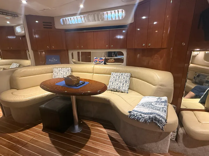 Slide: The Image of Luxurious interior of 2003 Sea Ray 380 Sundancer yacht with leather seating and wooden cabinetry. - 19