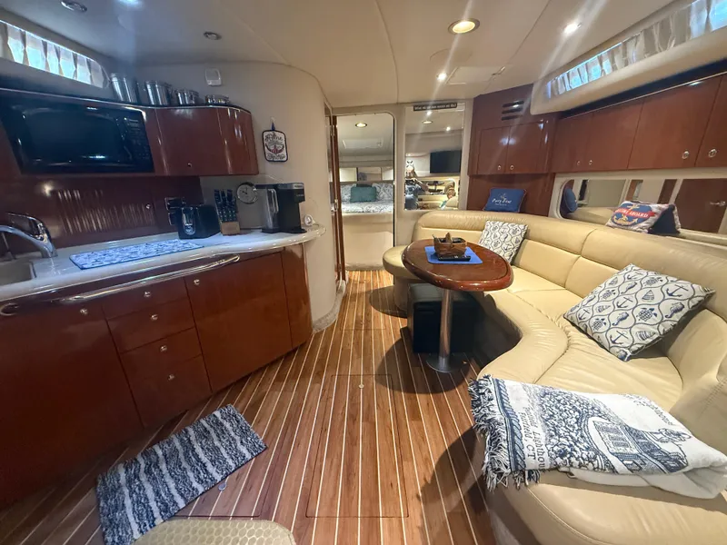 Slide: The Image of Luxurious interior of 2003 Sea Ray 380 Sundancer yacht with kitchen and seating area. - 20