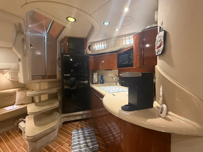 Slide: The Image of Luxurious interior of 2003 Sea Ray 380 Sundancer yacht with kitchenette and seating area. - 23