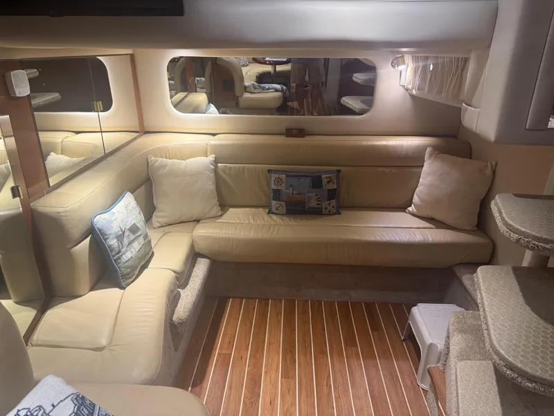 Slide: The Image of Luxurious interior of 2003 Sea Ray 380 Sundancer yacht with beige leather seating and decorative pillows. - 27
