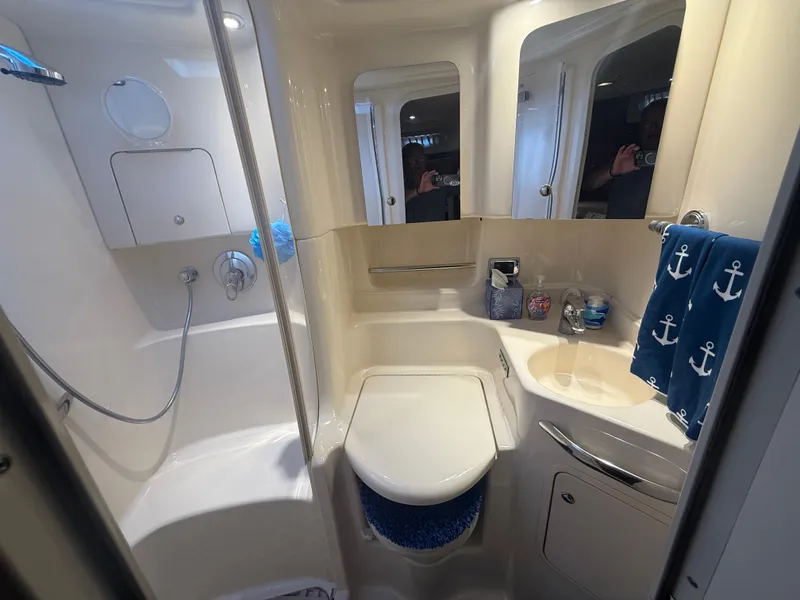 Slide: The Image of Bathroom interior of 2003 Sea Ray 380 Sundancer yacht, featuring shower and nautical decor. - 28