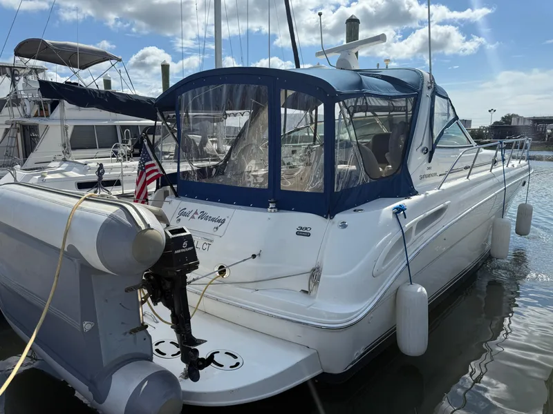Slide: The Image of 2003 Sea Ray 380 Sundancer yacht docked at marina under blue sky. - 8